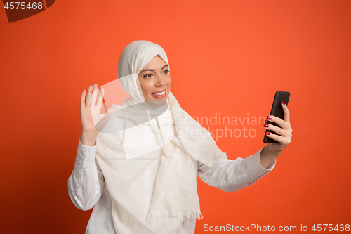 Image of Happy arab woman in hijab. Portrait of smiling girl, posing at studio background