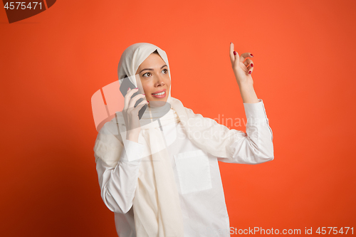 Image of Happy arab woman in hijab. Portrait of smiling girl, posing at studio background