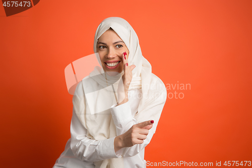 Image of Happy arab woman in hijab. Portrait of smiling girl, posing at studio background
