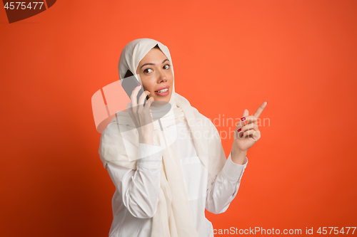 Image of Happy arab woman in hijab. Portrait of smiling girl, posing at studio background