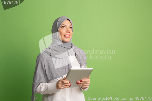 Image of Happy arab woman in hijab. Portrait of smiling girl, posing at studio background