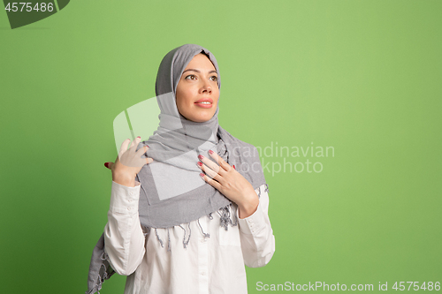 Image of Happy arab woman in hijab. Portrait of smiling girl, posing at studio background