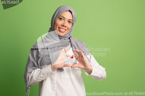 Image of Happy arab woman in hijab. Portrait of smiling girl, posing at studio background