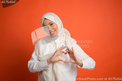 Image of Happy arab woman in hijab. Portrait of smiling girl, posing at studio background
