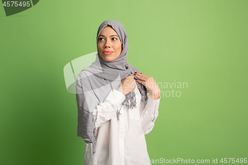 Image of Happy arab woman in hijab. Portrait of smiling girl, posing at studio background