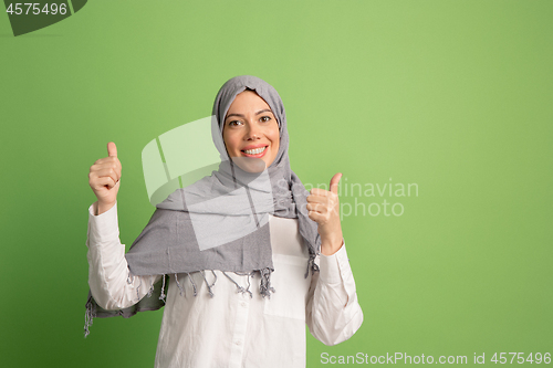 Image of Happy arab woman in hijab. Portrait of smiling girl, posing at studio background