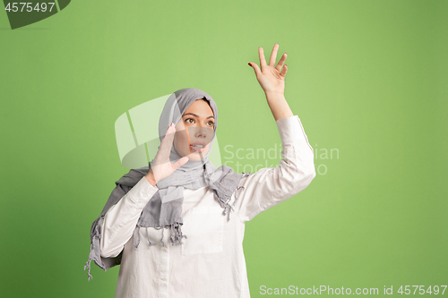 Image of Happy arab woman in hijab. Portrait of smiling girl, posing at studio background