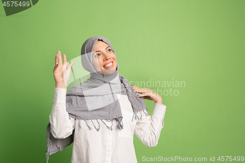 Image of Happy arab woman in hijab. Portrait of smiling girl, posing at studio background