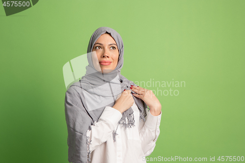 Image of Happy arab woman in hijab. Portrait of smiling girl, posing at studio background