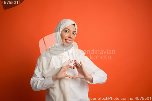 Image of Happy arab woman in hijab. Portrait of smiling girl, posing at studio background