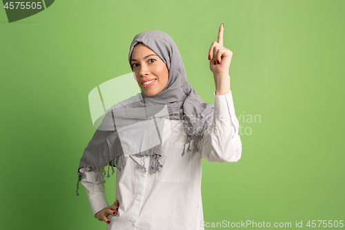 Image of Happy arab woman in hijab. Portrait of smiling girl, posing at studio background