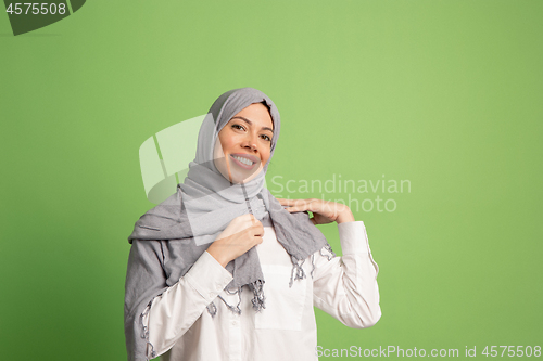 Image of Happy arab woman in hijab. Portrait of smiling girl, posing at studio background
