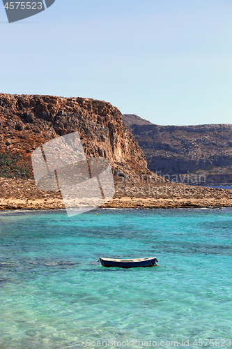 Image of Sea view with clear turquoise water and empty boat, Crete island