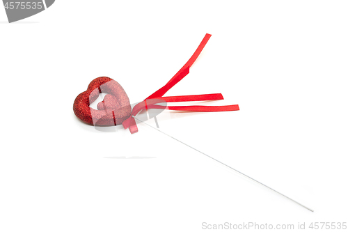 Image of Love symbol in the shape of a heart with red ribbon