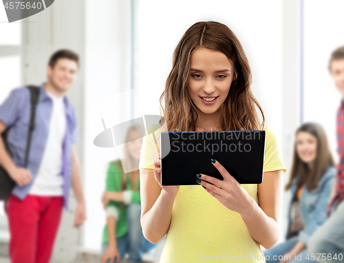 Image of young woman or teenage girl using tablet computer