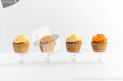 Image of cupcakes with frosting on confectionery stands