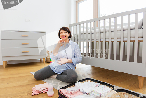 Image of pregnant woman packing bag for maternity hospital