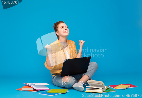 Image of happy student girl with laptop celebrating success