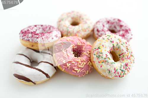 Image of close up of glazed donuts on white table