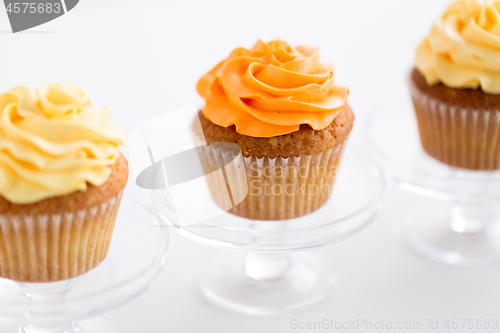 Image of cupcakes with frosting on confectionery stands