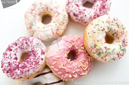 Image of close up of glazed donuts on white table