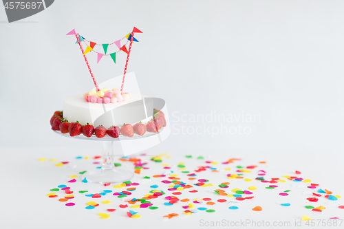 Image of close up of birthday cake with garland on stand