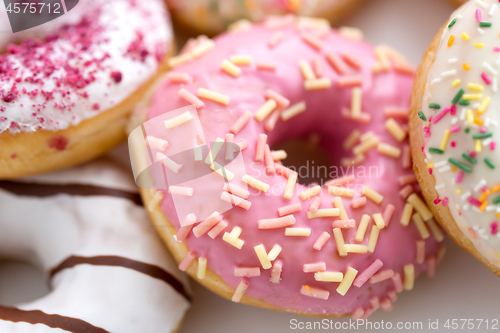 Image of close up of glazed donuts on white table