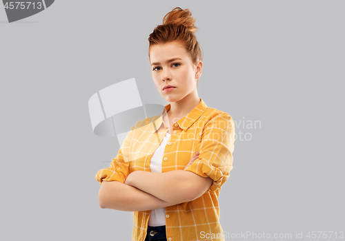 Image of serious red haired teenage girl with crossed arms