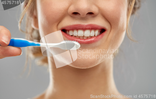 Image of close up of woman with toothbrush cleaning teeth