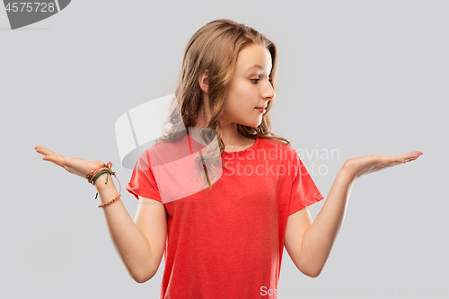 Image of smiling teenage girl holding empty hand