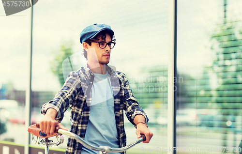 Image of hipster man walking with fixed gear bike