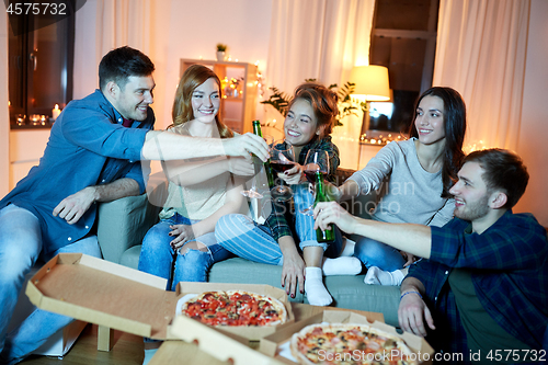 Image of happy friends with drinks and pizza party at home