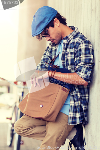 Image of hipster man with shoulder bag and fixed gear bike