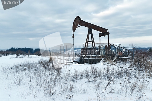 Image of Oil well on a winter landscape