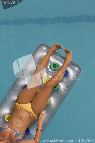 Image of young woman lying on inflatable sunbed
