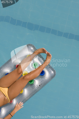 Image of young woman lying on inflatable sunbed