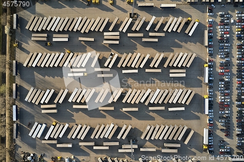 Image of Line of trucks and trailers from above at a cargo terminal