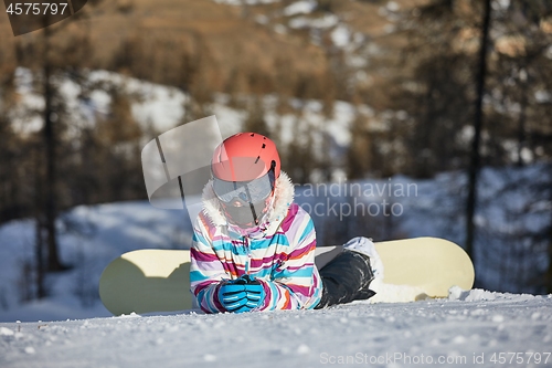 Image of Snowboarder resting in the snow