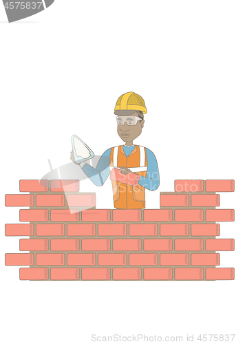 Image of Young bricklayer working with spatula and brick.