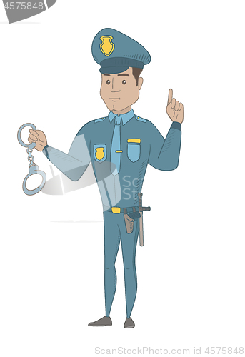 Image of Young hispanic policeman holding handcuffs.