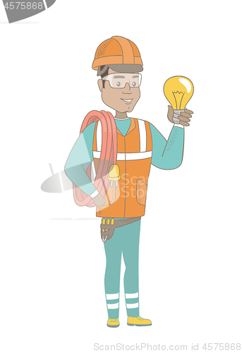Image of Young hispanic electrician holding a lightbulb.