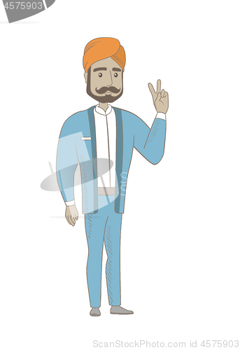 Image of Hindu businessman showing victory gesture.