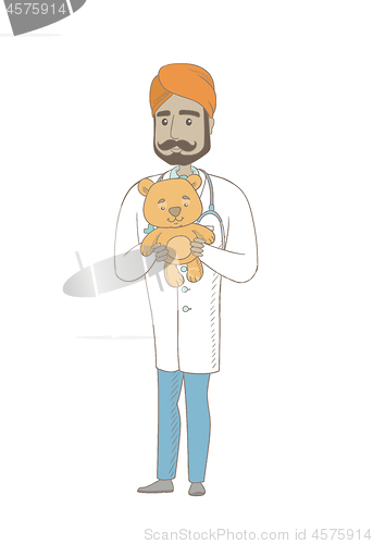 Image of Young indian pediatrician holding teddy bear.