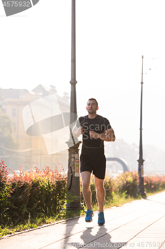 Image of man jogging at sunny morning