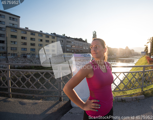 Image of portrait of a jogging woman at sunny morning