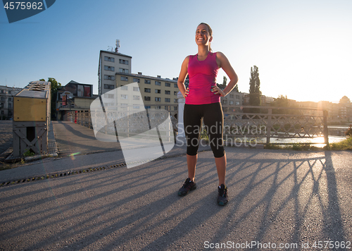 Image of portrait of a jogging woman at sunny morning