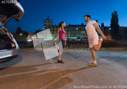 Image of couple warming up and stretching