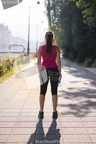 Image of woman jogging at sunny morning