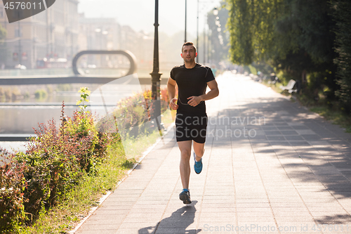 Image of man jogging at sunny morning