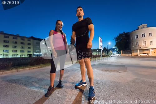 Image of couple warming up and stretching
